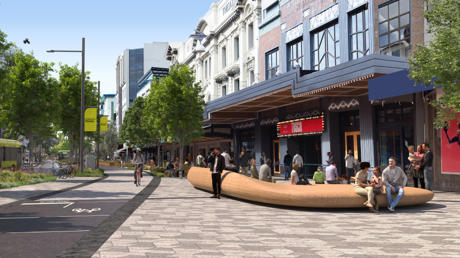 This is an artist's impression of Courtenay Place once completed. This image shows outside the St James Theatre. There is a large uranga/wooden sculpture on the right. This sculpture is acts as a resting place and is big enough for bands to play on it. It has been designed by mana whenua. On the left there is a two way cycleway.   People are sitting on the uranga, standing outside the theatre and biking on the cycle path. This is an artist's impression of Courtenay Place once completed. This image shows outside the St James Theatre. There is a large uranga/wooden sculpture on the right. This sculpture is acts as a resting place and is big enough for bands to play on it. It has been designed by mana whenua. On the left there is a two way cycleway.   People are sitting on the uranga, standing outside the theatre and biking on the cycle path. 